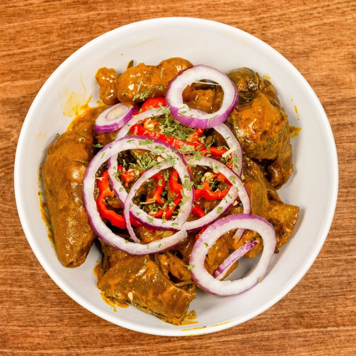White rice with stew and 1 pc meat in West African spices at Village Pot downtown Winnipeg
